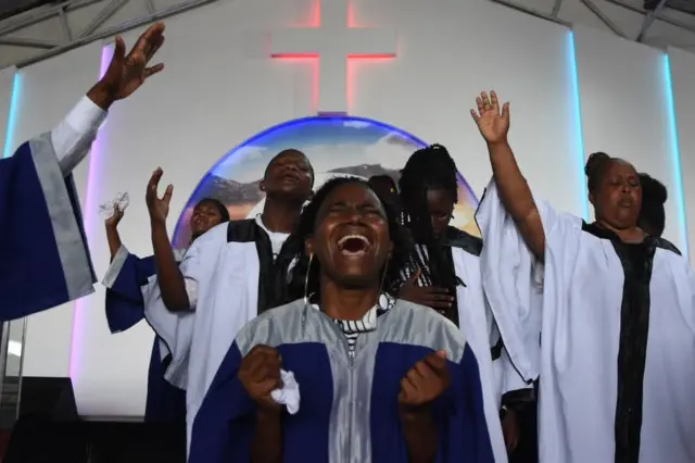 Choir members sing during the Sunday mass without wearing masks and social distancing at Ufunuo na Uzima Church.