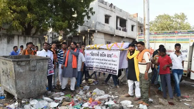 Activists stage a mock funeral to protest the BJPs development-focused campaign in Gujarat 2017