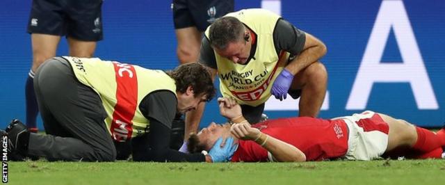Dan Biggar receives treatment during his side's win against Fiji
