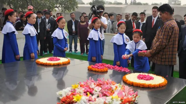 राजघाटावर गांधींच्या समाधीला फुलं वाहतांना कोरियन विद्यार्थी