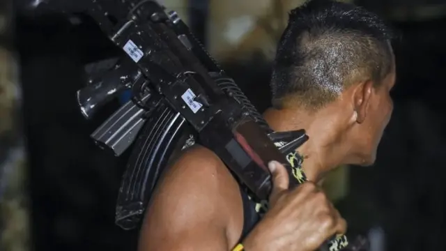 A member of the Revolutionary Armed Forces of Colombia (FARC) holds a weapon June 14 2017