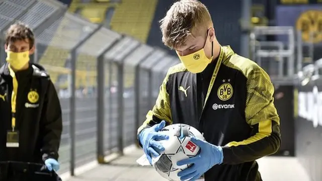 Ball boys disinfected footballs