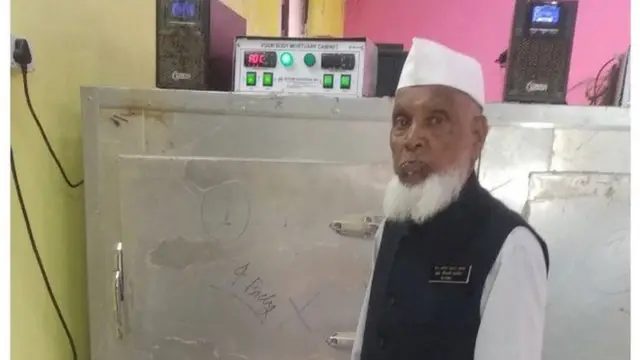 Shareef standing in front of a mortuary storage facility