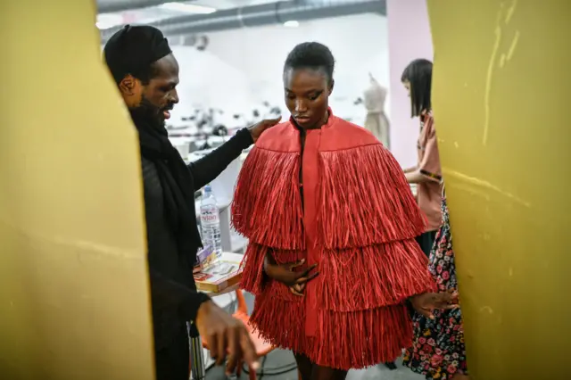 Cameroonian fashion designer Imane Ayissi supervises a model during the shooting of the video presentation of his Haute Couture Fall Winter 2021-2022 collection, in Paris, on July 3, 2021.