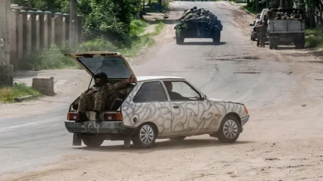 Soldiers in tanks and vehicles
