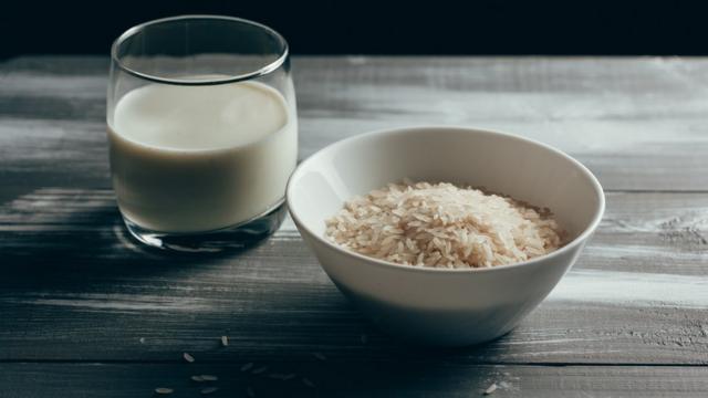 A bowl of rice and milk on a table.