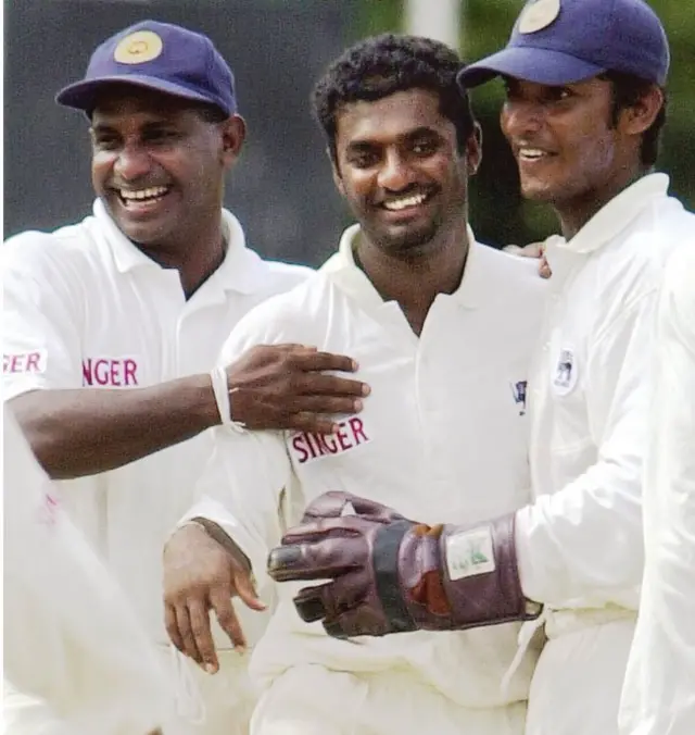 Sri Lankan skipper Sanath Jayasuriya (L) and team wicketkeeper Kumara Sangakkara (R) congratulate spinner Muttiah Muralitharan (C) after Muralitharan claimed the wicket of Indian batsman Sameer Dighe (not in picture) on the first day of the third and the final Test match between Sri Lanka and India at the Singhalese Sports Club cricket stadium in Colombo 29 August 2001. Muralithran took eight Indian wickets to restrict India to 234 all out in their first innings. Sri Lanka and India are tied 1-1 in the three-Test match series. AFP PHOTO/Arko DATTA / AFP P