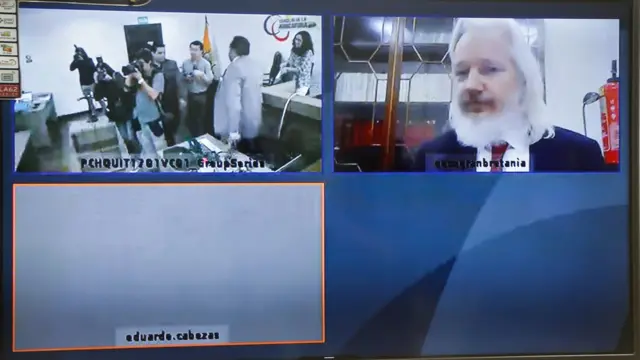 TOPSHOT - View of a screen showing WikiLeaks founder, Australian Julian Assange, in videoconference during a hearing at a provincial court in Quito on December 12, 2018. - Assange, 47, appealed a decision against Ecuador suspending a protocol -in force since October 12- which regulates his stay at the Ecuadorean Embassy in London.