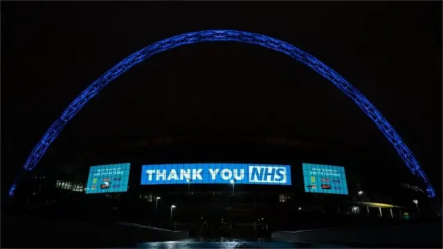 Wembley Stadium Arch in London lit up in blue
