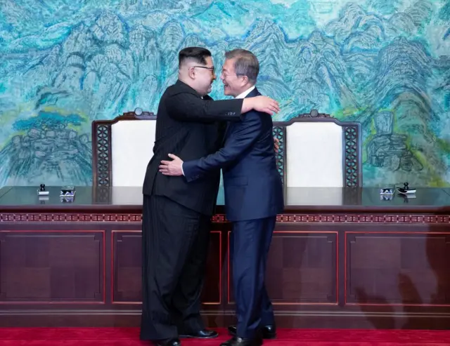 South Korean President Moon Jae-in and North Korean leader Kim Jong Un embrace at the truce village of Panmunjom inside the demilitarized zone separating the two Koreas, South Korea, April 27, 2018. Korea Summit Press Pool/Pool via Reuters