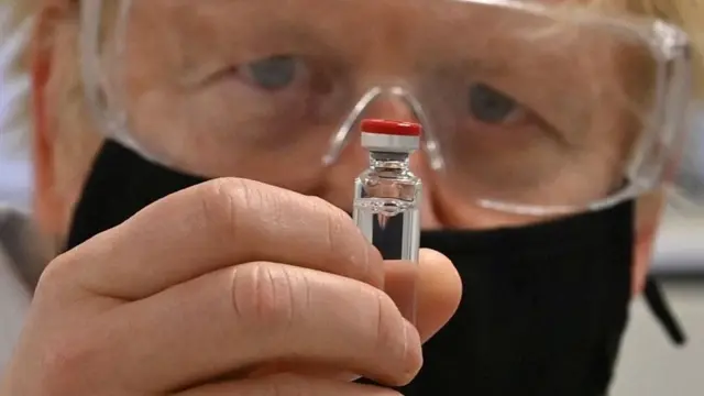 Boris Johnson holding the Oxford vaccine