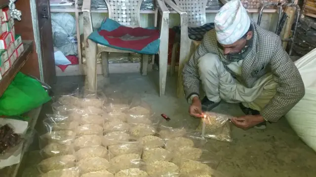 चामल प्याकेटमा हाल्दै