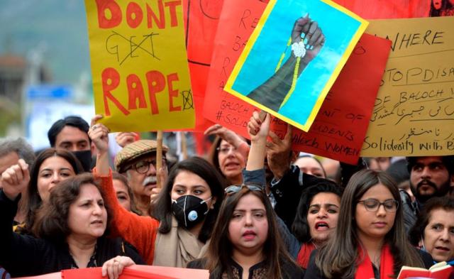 Activists of the Aurat (Woman) March shout slogans during a rally to mark International Women