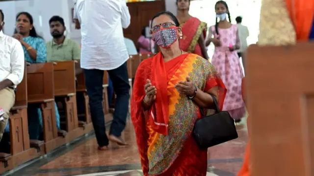 Christian devotees wearing facemasks as a preventive measure against the Covid-19 coronavirus offer prayers at Sacred Heart Shrine Church on Christmas in Chennai