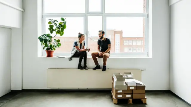 One man and one woman chatting in the office