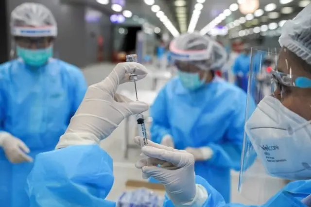 A medical worker prepares a syringe with a dose of China"s Sinovac coronavirus disease (COVID-19) vaccine at the Central Vaccination Center, inside the Bang Sue Grand Station, in Bangkok, Thailand