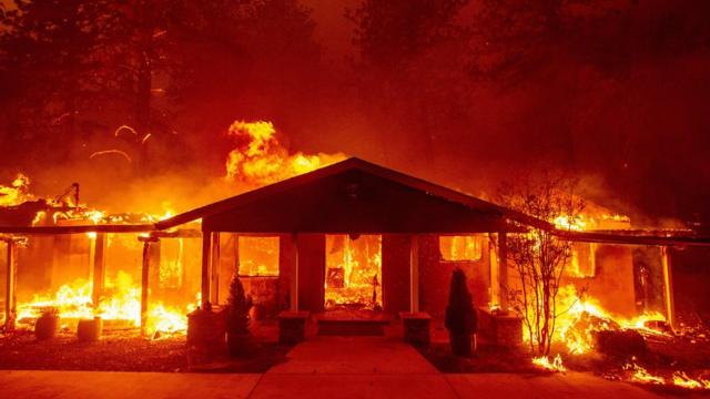 a home burns during the Camp fire in Paradise, California on November 8, 2018