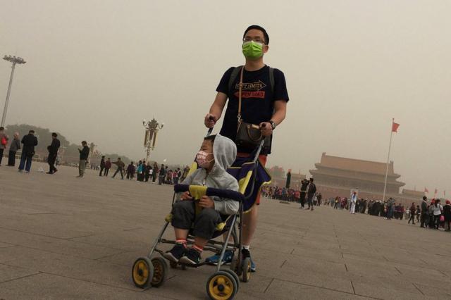 People visit Tiananmen Square as a dust storm hits Beijing, China 4 May 2017.