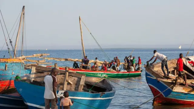 Fishermen tend to their boats on the shores of the Paquitequete neighborhood in Pemba.