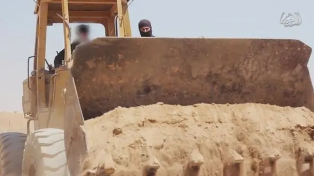 Screengrab of video posted online by IS purportedly showing militants bulldozing the border between Syria and Iraq (2014)