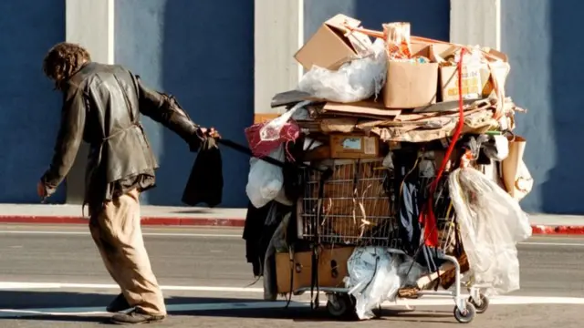 Homeless man pulling shopping trolley in Los Angeles