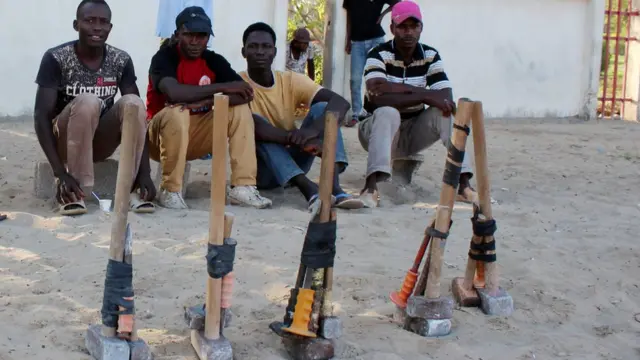 African migrants sit on the side of a road as they wait for work in Misrata, Libya 22/10/2017