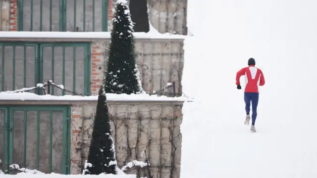 Un hombre corre en la nieve.