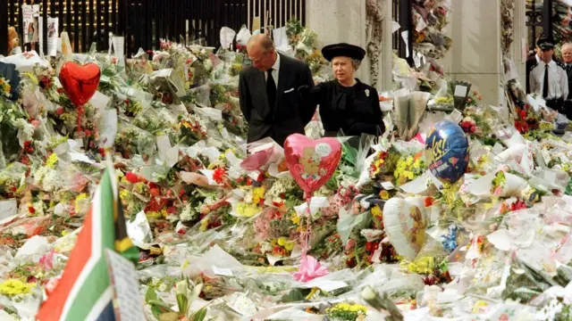 The Queen and Duke of Edinburgh look at the mass of floral tributes laid outside Buckingham Palace in memory of Diana, Princess of Wales