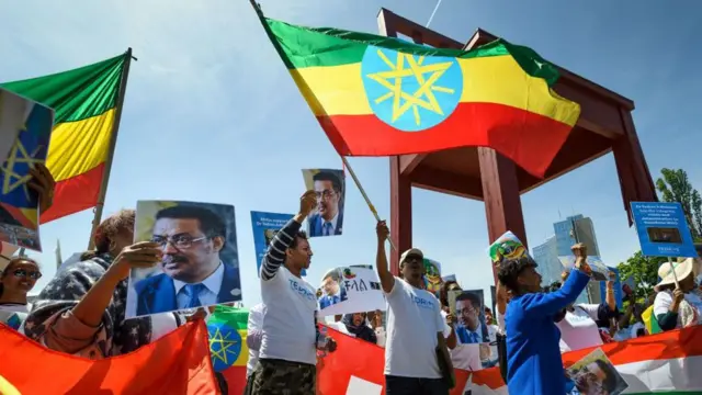 People waving Ethiopian flags