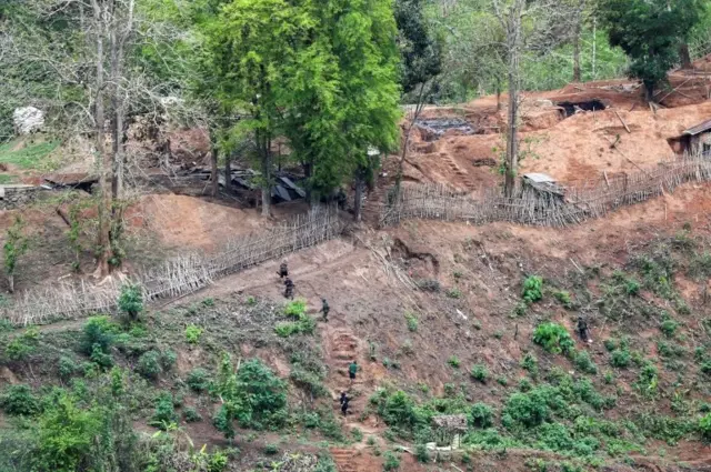 Ethnic minority Karen troops approach a Myanmar army outpost near the Thai border, which is seen from the Thai side on the Thanlwin, also known as Salween, riverbank in Mae Hong Son province, Thailand, April 28, 2021