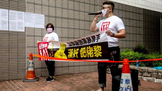 两名亲政府团体成员在香港西九龙裁判法院外抗议要求严惩黎智英（3/9/2020）