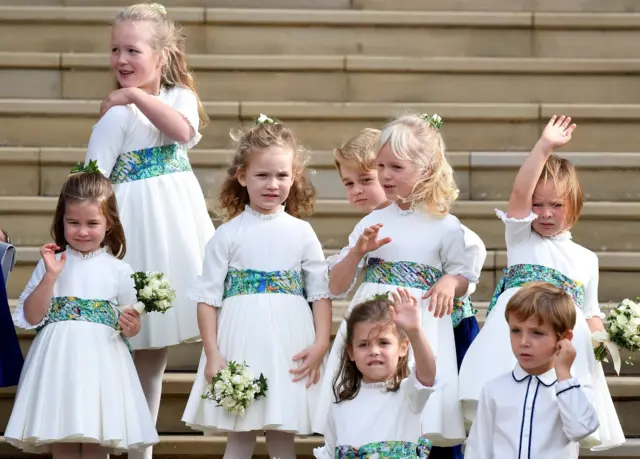 The bridesmaids and page boys, including Prince George and Princess Charlotte, wave as they leave after the royal wedding of Britain"s Princess Eugenie of York and her husband Jack Brooksbank at St George"s Chapel