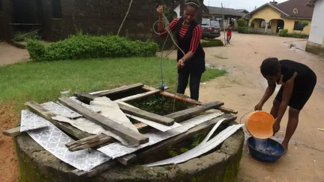 Girls wey dey fetch water from well.