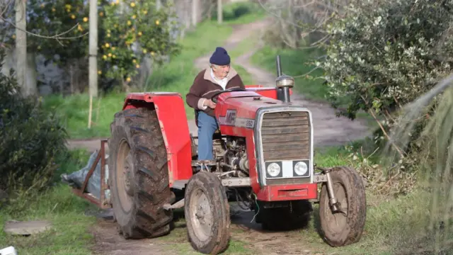Former Uruguayan President Jose Mujica drives a tractor