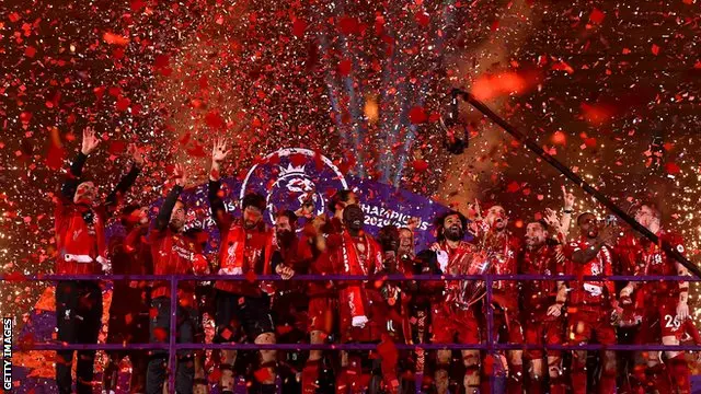Liverpool's players celebrate lifting the Premier League trophy