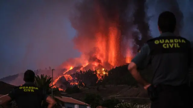 Miembros de la Guardia Civil en las Islas Canarias observan la erupción del volcán Cumbre Vieja.