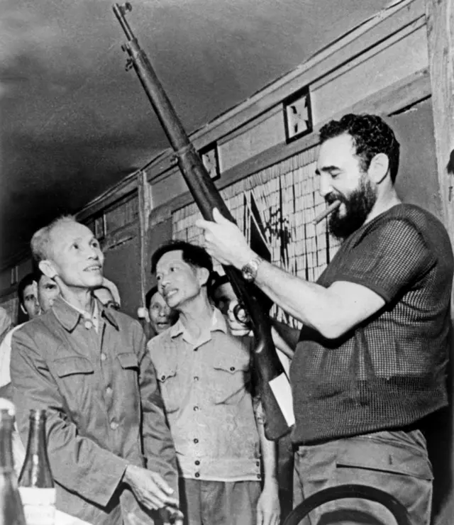 September 1973 shows Cuban president Fidel Castro (R) looking at a rifle during a visit in North Vietnam