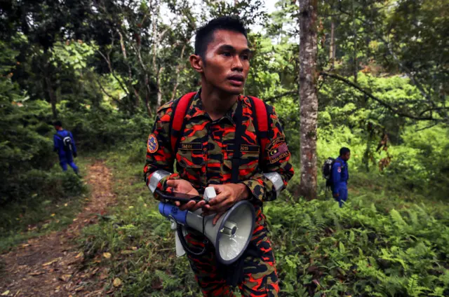 An officer from the Malaysian Fire and Rescue Department takes part in the search for 15-year-old Nora Quoirin