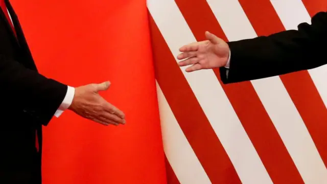 : U.S. President Donald Trump and China"s President Xi Jinping shake hands after making joint statements at the Great Hall of the People in Beijing, China,