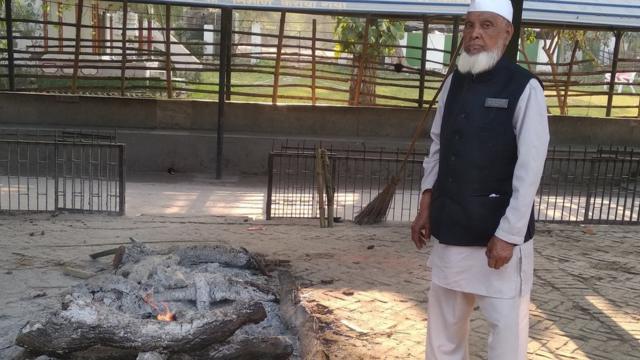 Shareef standing next to a funeral pyre