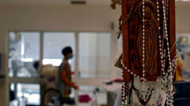 A number of rosaries hang in the corner of a Bueno Aires hospital