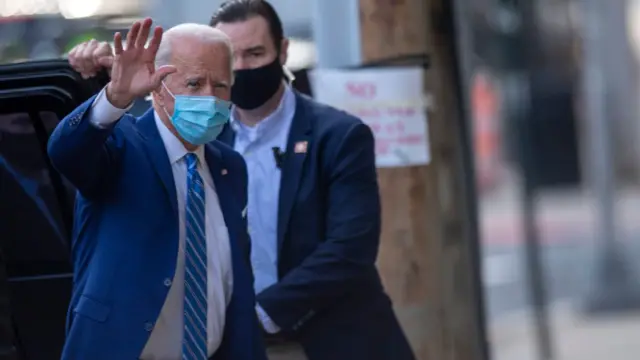 President-elect Joe Biden waves to the media while arriving to deliver a Thanksgiving address at the Queen Theatre on November 25, 2020