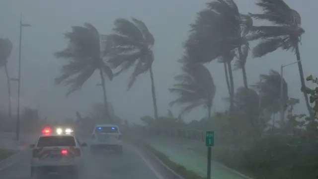 Police patrol the area as Hurricane Irma slams across islands in the northern Caribbean on Wednesday, in San Juan, Puerto Rico, 6 September