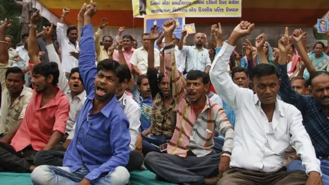 Members of India"s low-caste Dalit community shouts slogans during a sit in protest against the alleged attack on their community members for skinning a dead cow in Una, in Ahmadabad, India, Friday, July 22, 2016.
