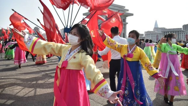 In this picture taken on April 11, 2022, students and youth take part in a dancing party to commemorate the 10th anniversary of North Korean leader Kim Jong Un's election as the top party and state leader
