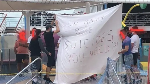 Manifestantes com faixas no convés do Majesty of the Seas.