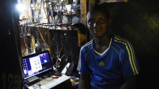 A roadside vendor in Lagos recharges his clients' smartphone in Lagos, Nigeria - Tuesday 22 March 2022