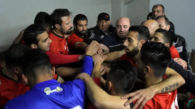 Al-Ittihad players huddle in the dressing room before the game