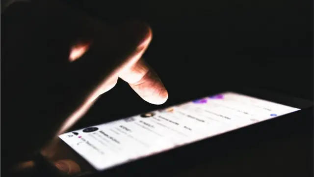 A person texting in the dark
