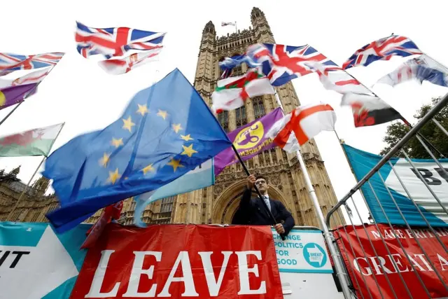 An anti-Brexit protester waves an EU flag outside the Houses ofÂ ParliamentÂ in London, Britain, October 25, 2019